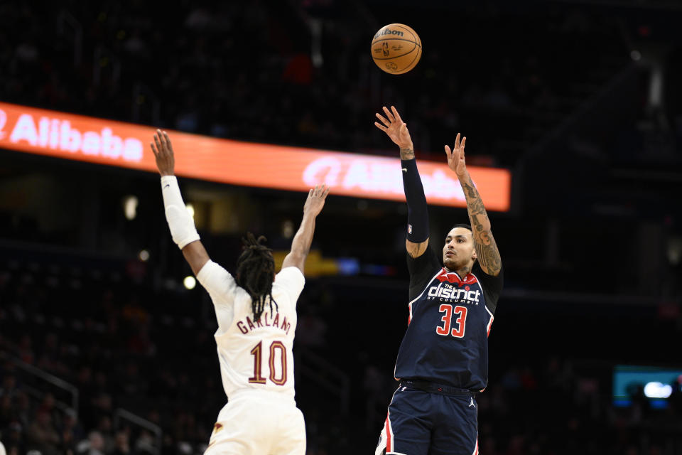 Washington Wizards forward Kyle Kuzma (33) shoots against Cleveland Cavaliers guard Darius Garland (10) during the first half of an NBA basketball game Wednesday, Feb 7, 2024, in Washington. (AP Photo/Nick Wass)