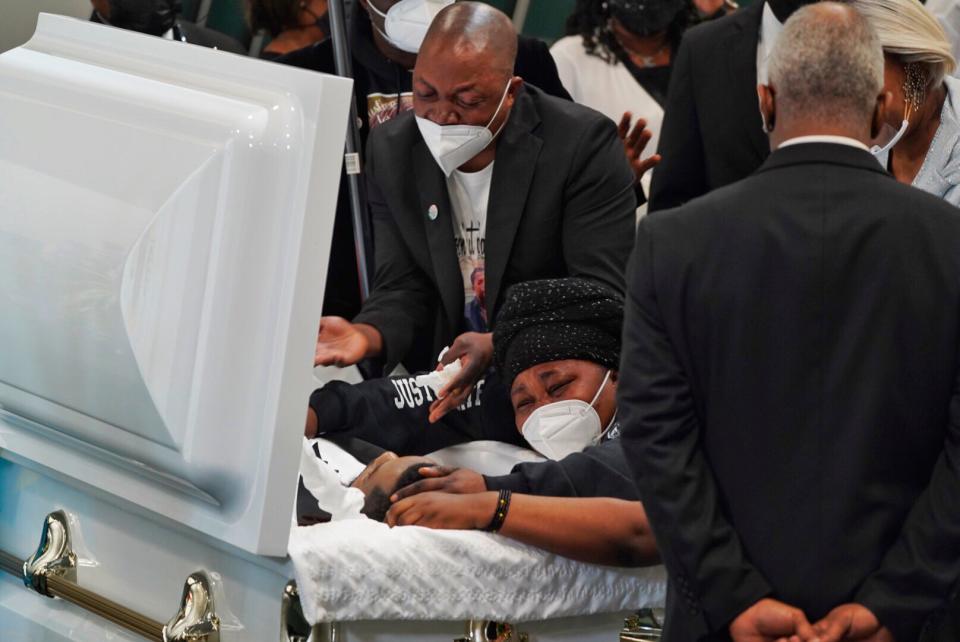 Peter Lyoya and his wife Dorcas Lyoya stop at the casket of their son Patrick Lyoya before his funeral at Renaissance Church of God in Christ in Grand Rapids on April 22, 2022. Patrick Lyoya was shot in the back of the head and killed by a Grand Rapids Police officer following a struggle during a traffic stop.