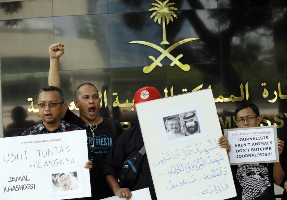 A dozen of Indonesian journalists hold posters with photos of Saudi writer Jamal Khashoggi during a protest outside Saudi Arabian Embassy in Jakarta, Indonesia, Friday, Oct. 19, 2018. A Turkish official said Friday that investigators are looking into the possibility that the remains of missing Saudi journalist Jamal Khashoggi may have been taken to a forest in the outskirts of Istanbul or to another city, if and after he was killed inside the Saudi Consulate in Istanbul earlier this month. (AP Photo/Achmad Ibrahim)