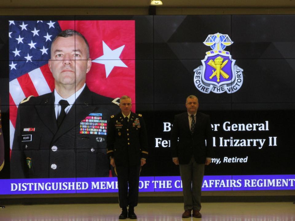 Retired Brig. Gen. Ferdinand Irizarry II is welcomed by Col. Charles Burnett as a distinguished member of the civil affairs regiment during a Nov. 4, 2021, ceremony at Fort Bragg.