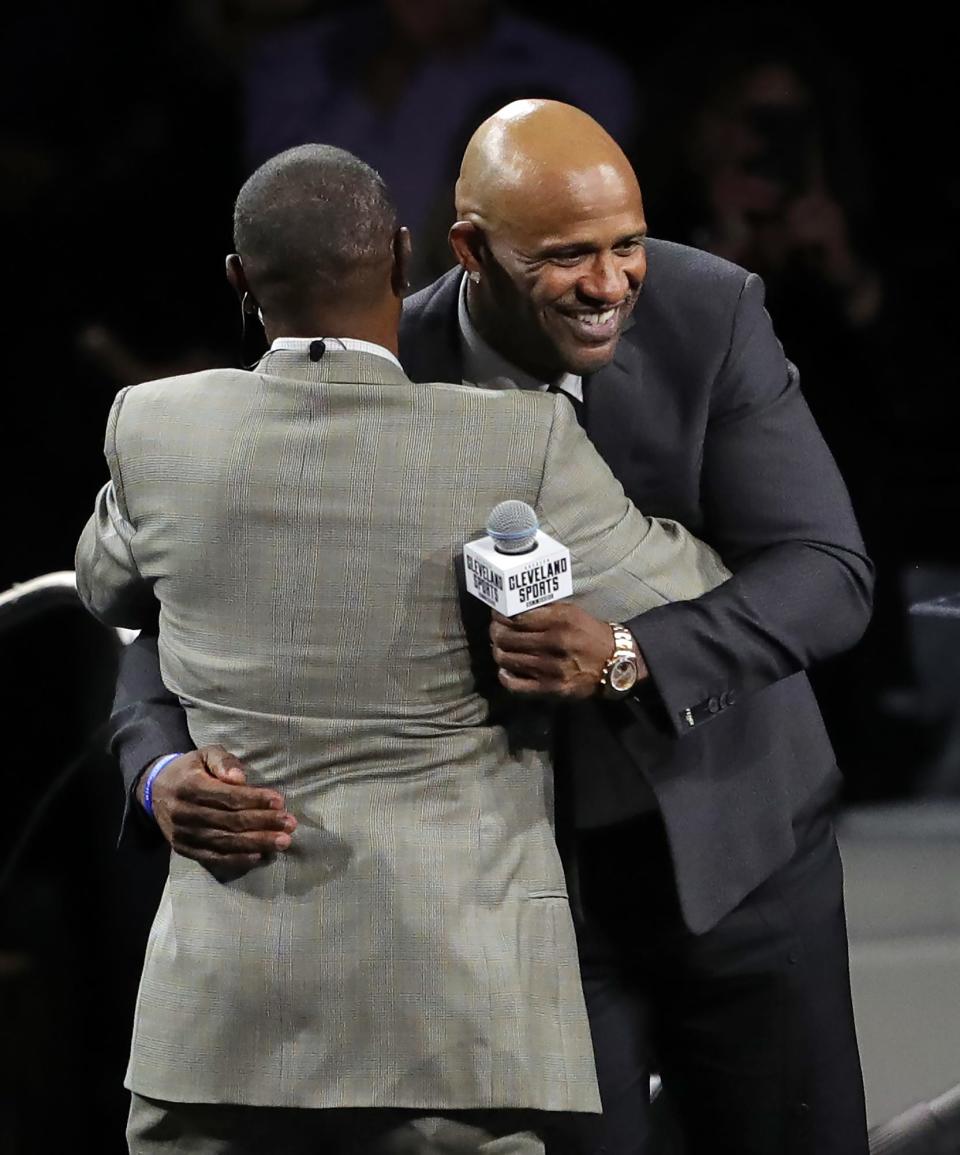 Former Cleveland pitcher CC Sabathia, facing, hugs former outfielder Kenny Lofton as he takes the stage to accept the Lifetime Achievement Award during the 22nd Greater Cleveland Sports Awards at Rocket Mortgage FieldHouse on Wednesday.