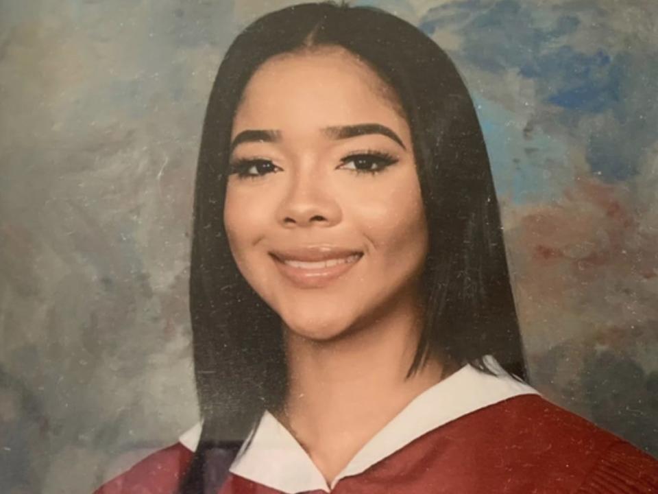 A girl smiling in a school picture.