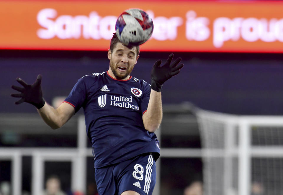New England Revolution midfielder Matt Polster heads the ball during the first half of the team's MLS soccer match against CF Montreal on Saturday, April 8, 2023, in Foxborough, Mass. (AP Photo/Mark Stockwell)