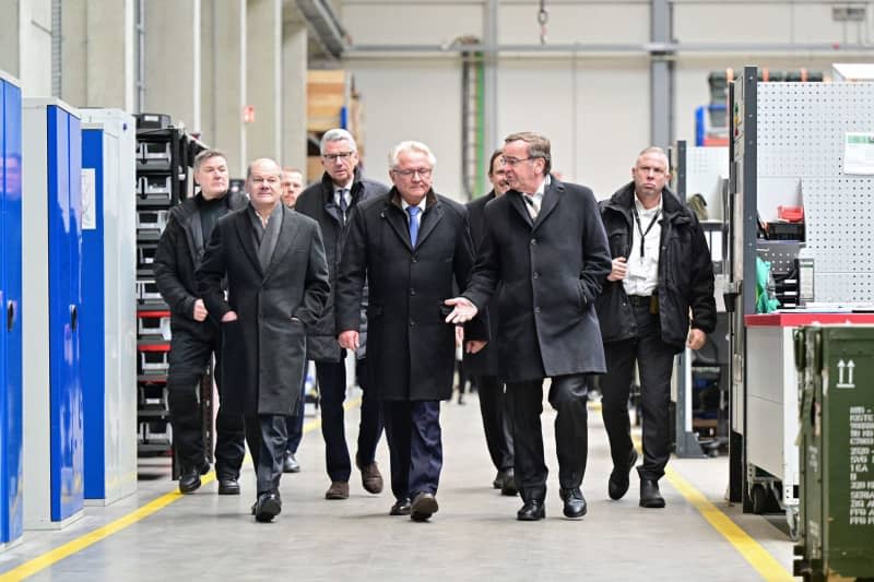 German Chancellor Olaf Scholz (2nd L), Armin Papperger (C), CEO of Rheinmetall, and Boris Pistorius (2nd R), German Minister of Defense, inspect a production hall of the Rheinmetall armaments company. Chancellor Scholz attends a symbolic ground-breaking ceremony to mark the start of construction of a new Rheinmetall ammunition factory. The ammunition factory will produce artillery ammunition, explosives and rocket artillery. Philipp Schulze/dpa