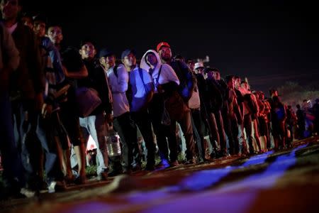 Migrants, part of a caravan traveling from Central America en route to the United States, wait to hitchhike after resting in a makeshift camp in Matias Romero Avendano, Mexico, November 10, 2018. REUTERS/Ueslei Marcelino