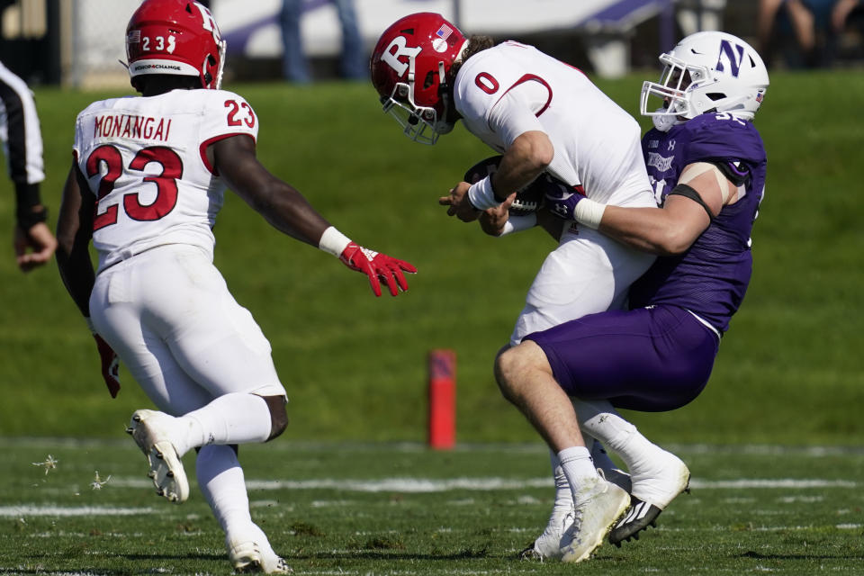Rutgers quarterback Noah Vedral (0) is sacked by Northwestern linebacker Bryce Gallagher as running back Kyle Monangai, left, looks on during the first half of an NCAA college football game in Evanston, Ill., Saturday, Oct. 16, 2021. (AP Photo/Nam Y. Huh)
