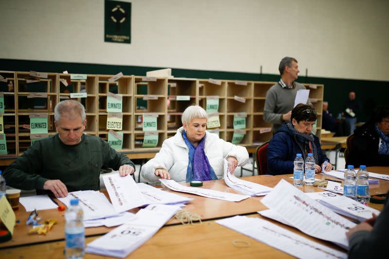 Staff members count votes during Ireland's national election, in Cork