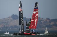 Oracle Team USA (L) follows Emirates Team New Zealand (R) during Race 18 of the 34th America's Cup yacht sailing race in San Francisco, California September 24, 2013. REUTERS/Stephen Lam (UNITED STATES - Tags: SPORT YACHTING)