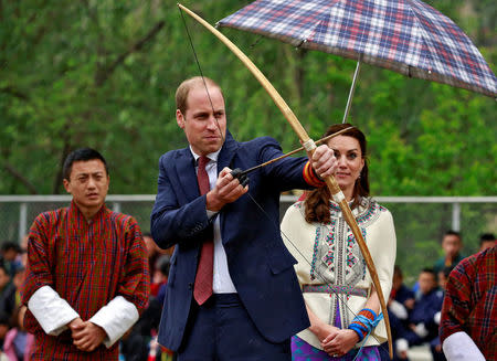 Britain's Prince William, Duke of Cambridge prepares to shoot an arrow as Catherine, Duchess of Cambridge looks on at Changlimithang Archery Ground in Thimphu, Bhutan, April 14, 2016. REUTERS/Cathal McNaughton