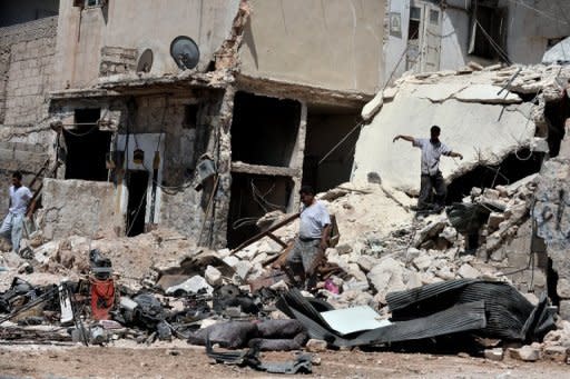 Civilians search for personal belongings in the rubble of their house following shelling from Syrian government forces in the northern city of Aleppo on August 25. Syrian President Bashar al-Assad said on Sunday the foreign "conspiracy" against his country would be defeated, as his forces were accused of a bloody rampage