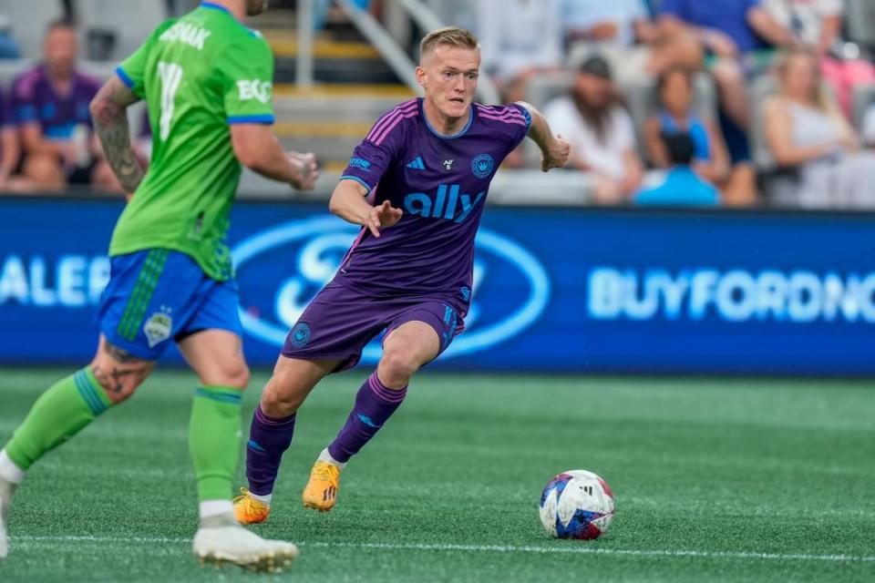 Charlotte FC forward Karol Swiderski (11) moves the ball into a scoring position against the Seattle Sounders during Saturday’s first half at Bank of America Stadium. Jim Dedmon-USA TODAY Sports