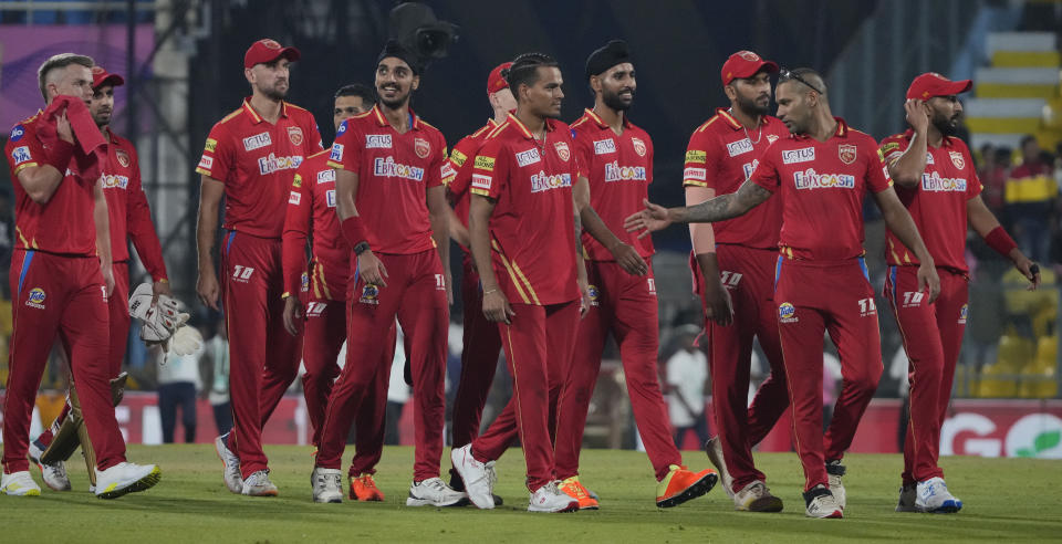 Punjab Kings' captain Shikhar Dhawan, second left, with his team walks back to pavilion after wining against Rajasthan Royals, in Guwahati, India, Wednesday, April 5, 2023. (AP Photo/Anupam Nath)