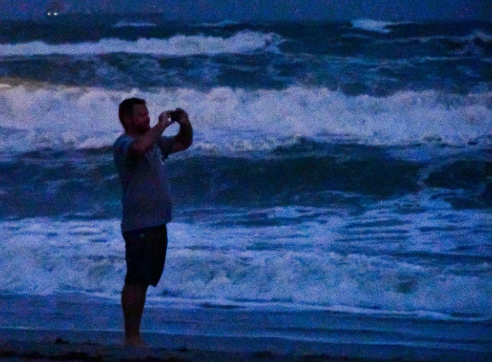 In almost total darkness, the waves are captured on a phone. Tuesday night with the full moon and high tide the waves  were pounding the beaches. 