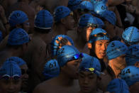 Competitors line up for a harbor race at the Victoria Harbor in Hong Kong, Sunday, Dec. 12, 2021. Hundreds of people took part in traditional swim across iconic Victoria Harbor after two years of suspension. (AP Photo/Kin Cheung)