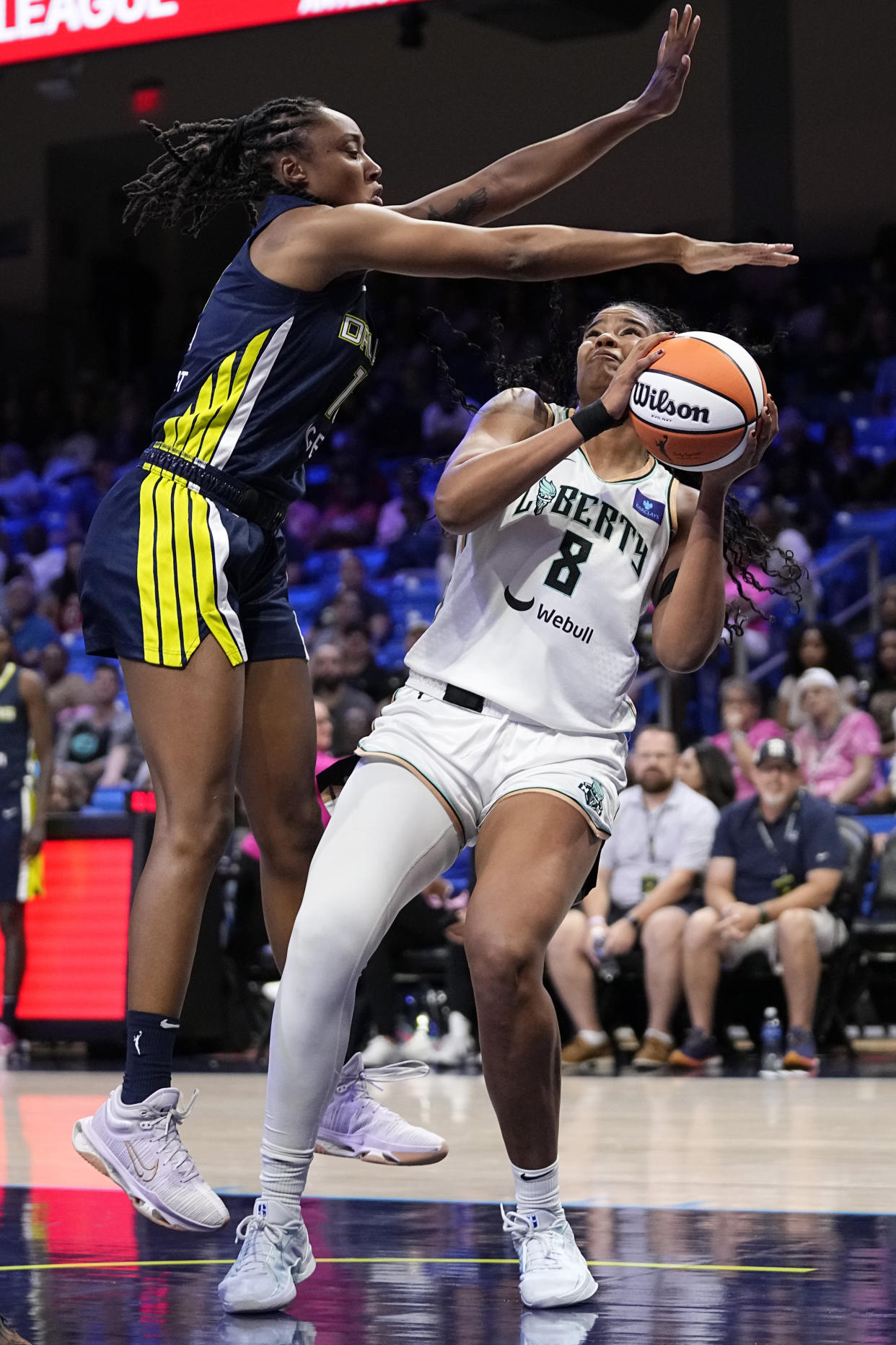 New York Liberty forward Nyara Sabally (8) works to take a shot as Dallas Wings' Jaelyn Brown, left, defends in the second half of a WNBA basketball game, Thursday, Sept. 12, 2024, in Arlington, Texas. (AP Photo/Tony Gutierrez)