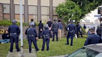 This video still image provided by KABC-TV shows protesters being detained prior to being arrested by Los Angeles police officers on Wednesday, Dec. 27, 2023, near Los Angeles International Airport. Pro-Palestinian protesters briefly blocked entrance roads to airports in New York and Los Angeles on Wednesday, forcing some travelers to set off on foot to bypass the jammed roadway. (KABC-TV via AP)