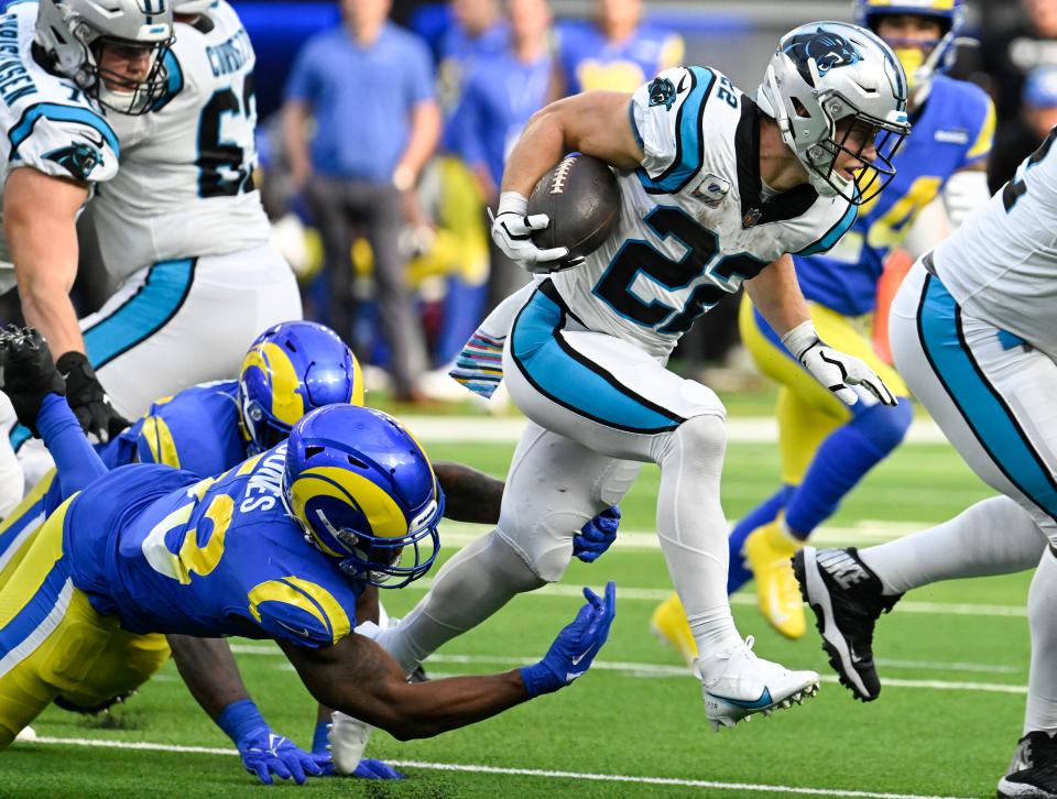 The Bucs will not have to deal with stopping running back Christian McCaffrey, here trying to break a tackle by Rams linebacker Ernest Jones last week, as he was traded to the 49ers this week.