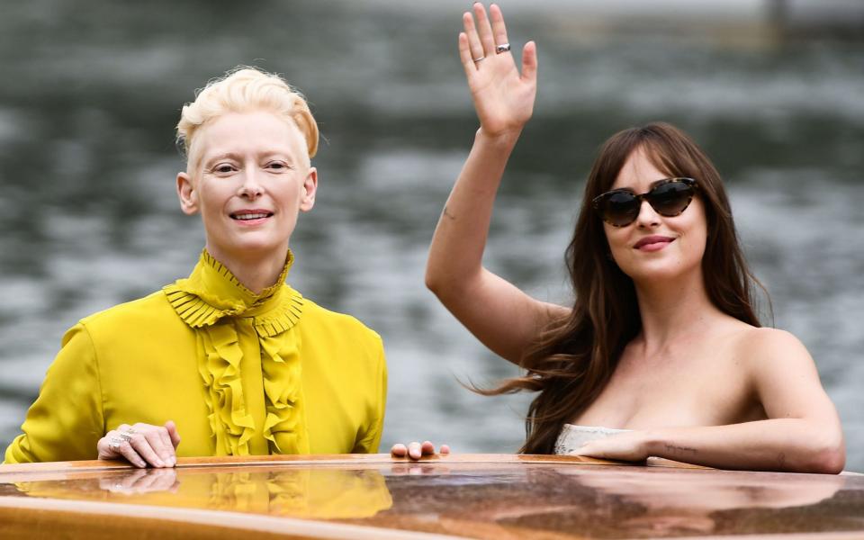 Actresses Dakota Johnson (R) and Tilda Swinton arrive by boat at the Excelsior Hotel's pier on September 1, 2018 during the 75th Venice Film Festival - AFP