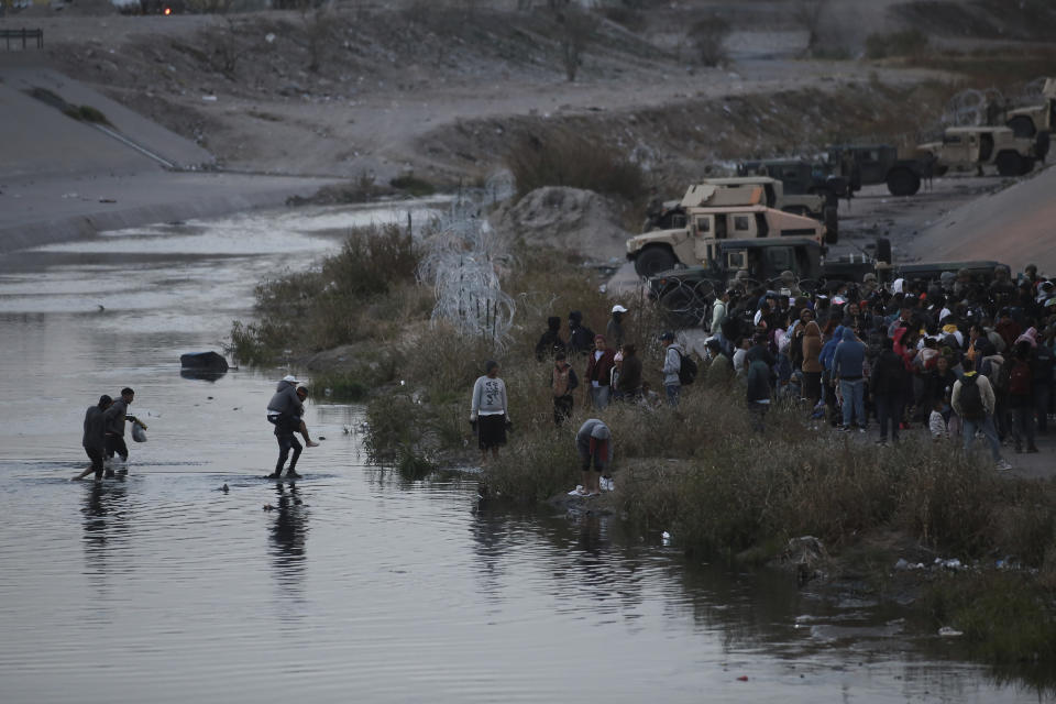 Migrants cross the Rio Grande towards the U.S.-Mexico border in Ciudad Juarez, Mexico, Tuesday, Dec. 20, 2022. Tensions remained high at the U.S-Mexico border Tuesday amid uncertainty over the future of restrictions on asylum-seekers, with the Biden administration asking the Supreme Court not to lift the limits before Christmas. (AP Photo/Christian Chavez)