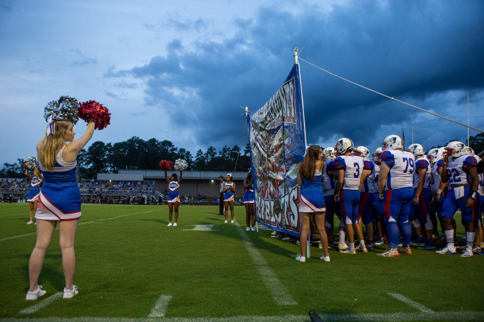 Oglethorpe County players line up behind the banner at a high school football game between Athens Christian High School and Oglethorpe County High School at Athens Christian High School in Athens, Ga. on Friday, September 18, 2020. Athens Christian won the game 20-6.