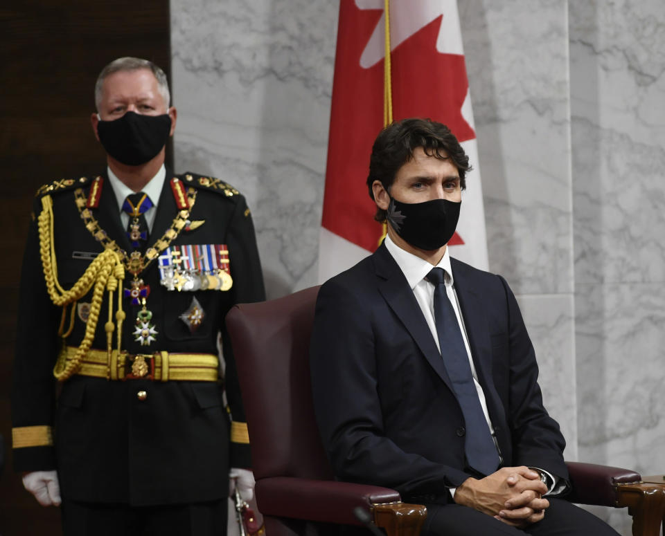 Chief of Defence Staff Jonathan Vance, left, and Canadian Prime Minister Justin Trudeau listen to Gov. Gen. Julie Payette deliver the throne speech in the Senate chamber in Ottawa, Ontario, on Wednesday, Sept. 23, 2020. (Adrian Wyld/The Canadian Press via AP)