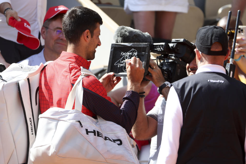 Novak Djokovic of Serbia writes in Serbian on the camera lens a political statement, 'Kosovo is the heart of Serbia. Stop the violence' about the tensions between Kosovo and Serbia after his first round victory during day 2 of the 2023 French Open, Roland-Garros 2023, second Grand Slam tennis tournament of the season at Stade Roland-Garros on May 29, 2023 in Paris, France.