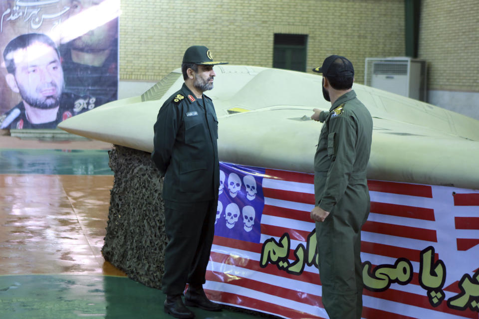 A photo released by Iran in 2011 purports to show Gen. Amir Ali Hajizadeh, left, the chief of the aerospace division of the Iran Revolutionary Guard Corps, listening to an unidentified colonel as he points to a downed U.S. RQ-170 Sentinel drone