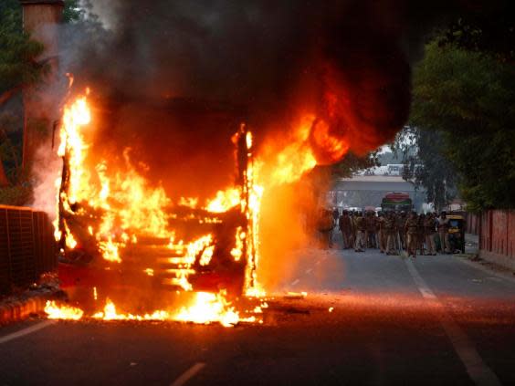 A passenger bus goes up in flames during a protest against Citizenship Amendment Act in New Delhi, India (AP)