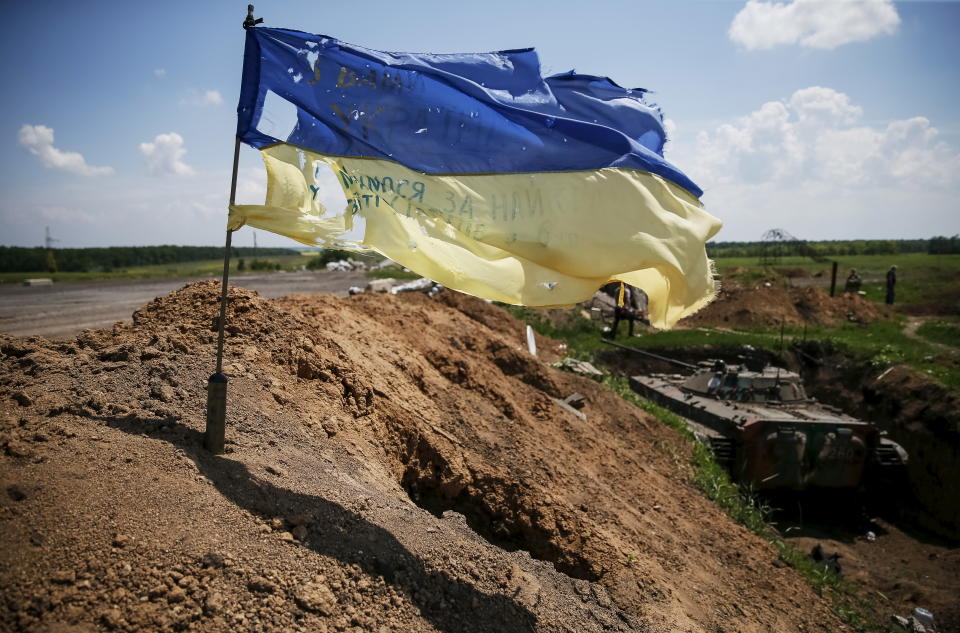 A tattered Ukrainian national flag flutters in the wind at a position held by the Ukrainian armed forces near the town of Maryinka, eastern Ukraine, June 5, 2015. Ukraine's president told his military on Thursday to prepare for a possible 