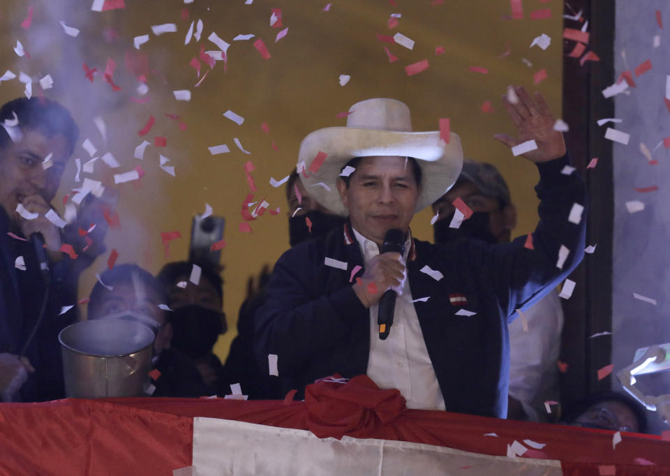 Pedro Castillo waves to supporters after election authorities declared him president-elect during celebrations at his party's campaign headquarters in Lima, Peru, Monday, July 19, 2021. Castillo was declared president more than a month after elections took place and after opponent Keiko Fujimori claimed that the election was tainted by fraud. (AP Photo/Guadalupe Prado)