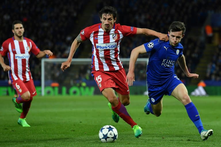 Atletico Madrid's defender Stefan Savic (C) vies with Leicester City's defender Ben Chilwell during the UEFA Champions League quarter-final second leg football match April 18, 2017