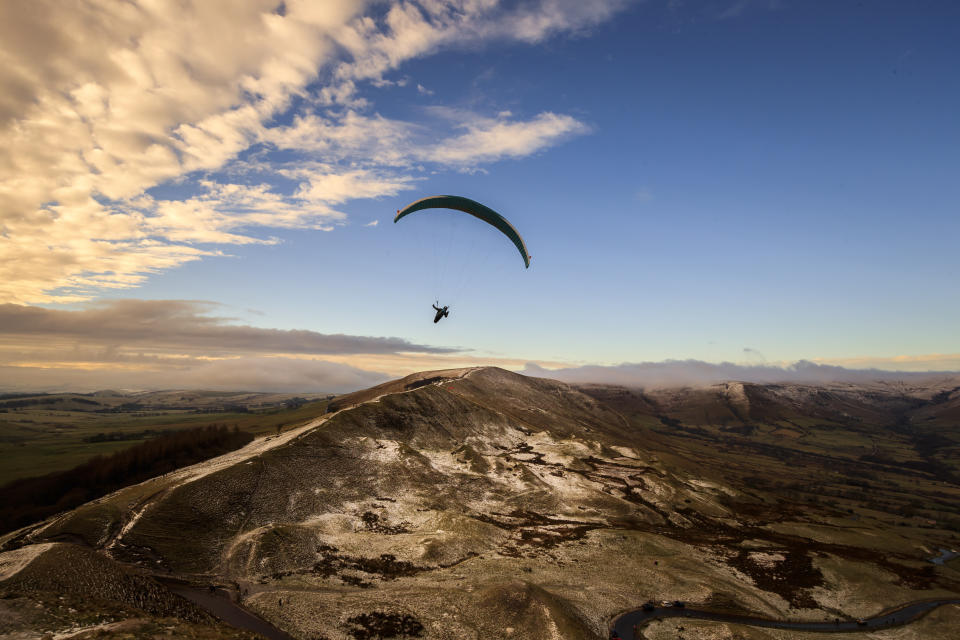 A paraglider flying over Mam Tor, a 517m hill near Castleton in Derbyshire. (Photo by Danny Lawson/PA Images via Getty Images)