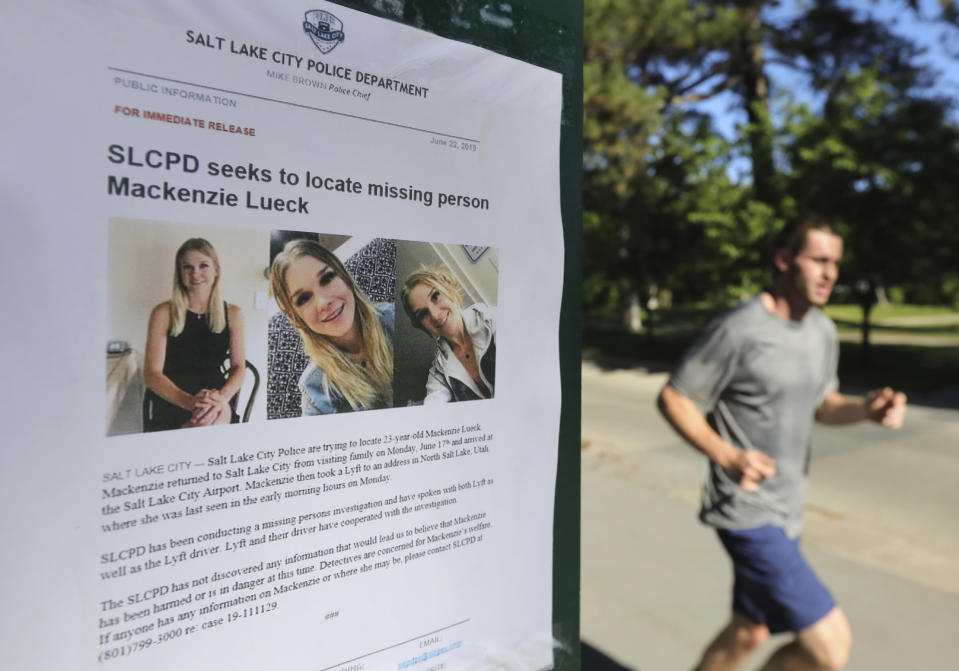 CORRECTS SPELLING OF LUECK - A joggers runs pass a poster of MacKenzie Lueck at Liberty Park Monday, June 24, 2019, in Salt Lake City. Police and friends are investigating the disappearance of the 23-year-old University of Utah student, whose last communication with her family said she arrived at Salt Lake City International Airport on Monday, June 17. (AP Photo/Rick Bowmer)