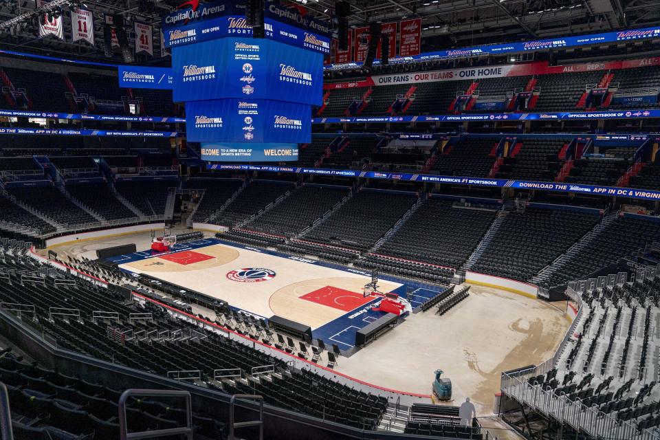 FILE - Screens display the William Hill Sportsbook logo at Monumental Sports & Entertainment's Capital One Arena in Washington, Wednesday, May 26, 2021. Virginia Gov. Glenn Youngkin says he has reached a tentative agreement, Wednesday, Dec. 13, 2023, with the parent company of the NBA’s Washington Wizards and NHL’s Washington Capitals to move those teams out of D.C. to northern Virginia.(AP Photo/Andrew Harnik, File)