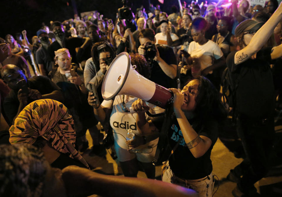 FILE - LaShell Eikerenkoetter chants, on a megaphone protesting the recent acquittal of a white former police officer, Jason Stockley, in the killing of a black man, Anthony Lamar Smith, on Friday, Sept. 22, 2017 in St. Charles, Mo. On Aug. 3, Mayor Tishaura Jones signed into law an ordinance establishing a Division of Civilian Oversight. But three police officer associations are suing to stop the measure that they claim hinders due process for officers and conflicts with state law. (David Carson/St. Louis Post-Dispatch via AP)