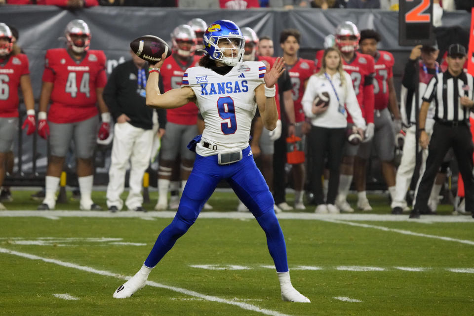 Kansas quarterback Jason Bean throws a pass against UNLV during the first half of the Guaranteed Rate Bowl NCAA college football game Tuesday, Dec. 26, 2023, in Phoenix. (AP Photo/Rick Scuteri)