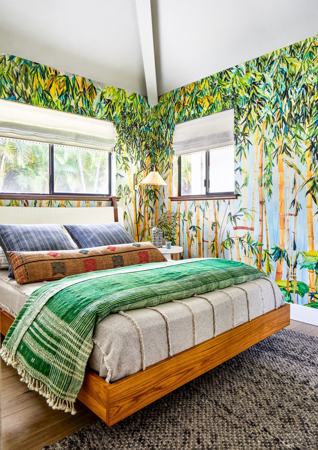 vacation home in maui, hawaii designed by breeze giannasio interiors cottage bedroom a jungle print voutsa mural sets a very hawaiian scene headboard norwegian wood, etsy bed frame article pillows st frank blue, chairish bolsters blankets shoppe by amber interiors cream and pom pom at home green shades the shade store side table crate barrel rug jaipur living