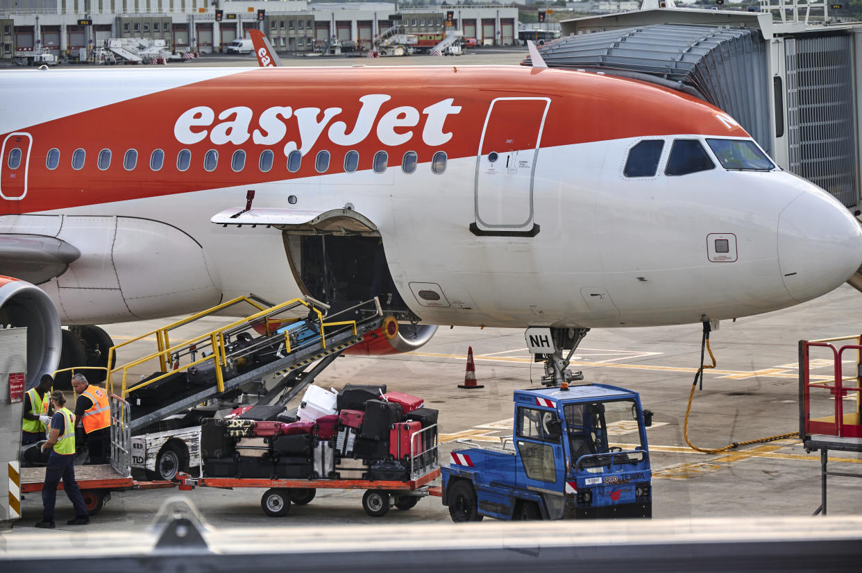 PARIS, FRANCE - AUGUST 31: Ramp personnel handle checked luggage out of easyJet Airbus A320-214 in Terminal 3 of Orly Airport on August 31, 2022 in Paris, France. Regular and low-cost airlines are enjoying a successful summer from the rebound in air transport activity in post COVID-19 pandemic era. (Photo by Horacio Villalobos#Corbis/Corbis via Getty Images)