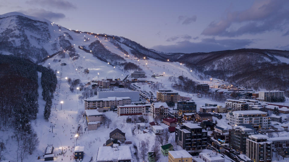 Aerial view at dusk of night skiing in Niseko Village. (Photo: Gettyimages)