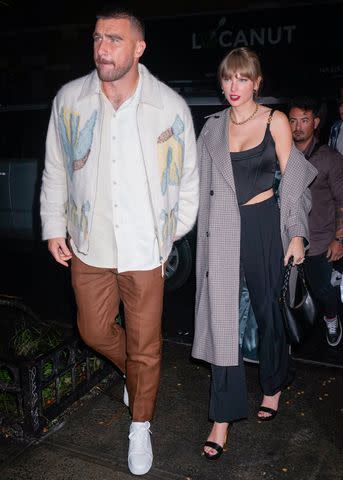 <p>Gotham/GC Images</p> Travis Kelce and Taylor Swift arrive at an 'SNL' afterparty on Oct. 12.