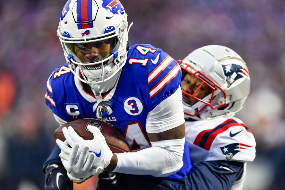 Buffalo Bills wide receiver Stefon Diggs (14) runs in a touchdown against New England Patriots cornerback Jonathan Jones (31) during the second half of an NFL football game, Sunday, Jan. 8, 2023, in Orchard Park. (AP Photo/Adrian Kraus)