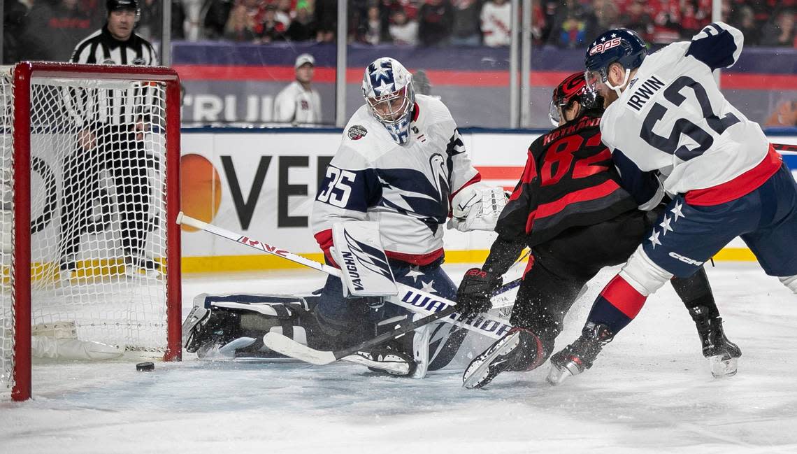 Carolina Hurricanes’ Jesperi Kotkaniemi (82) scores on Washington Capitals’ goalie Darcy Kuemper (35) to take a 1-0 lead in the first period during the Stadium Series game on Saturday, February 18, 2022 at Carter-Finley Stadium in Raleigh, N.C.