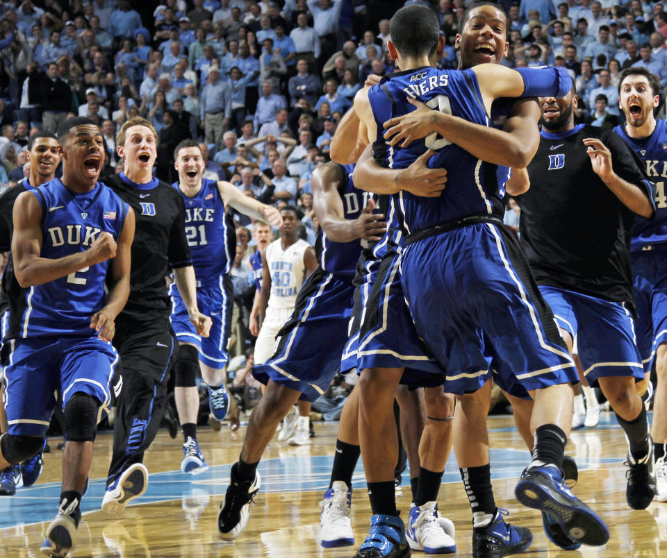 FILE - Duke guard Austin Rivers (0) celebrates with teammates after hitting the winning shot to down North Carolina 85-84 in an NCAA college basketball game in Chapel Hill, N.C., Wednesday, Feb. 8, 2012. (AP Photo/Jim R. Bounds, File)