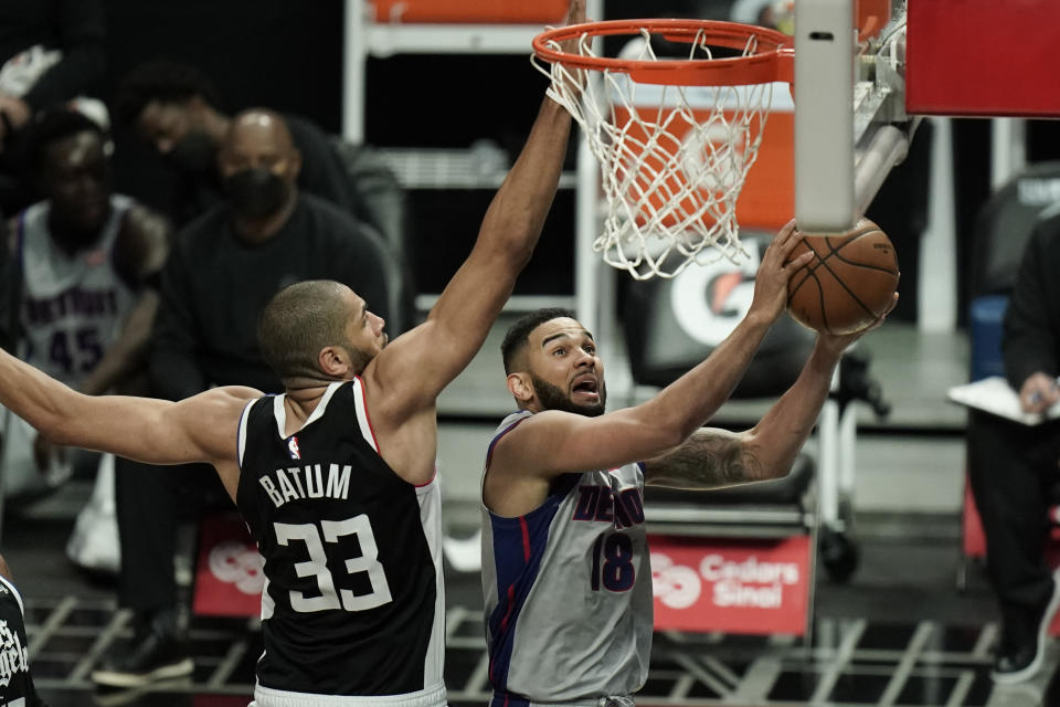 Detroit Pistons' Cory Joseph, right, goes up for a basket against Los Angeles Clippers' Nicolas Batum during the first half of an NBA basketball game Sunday, April 11, 2021, in Los Angeles. (AP Photo/Jae C. Hong)