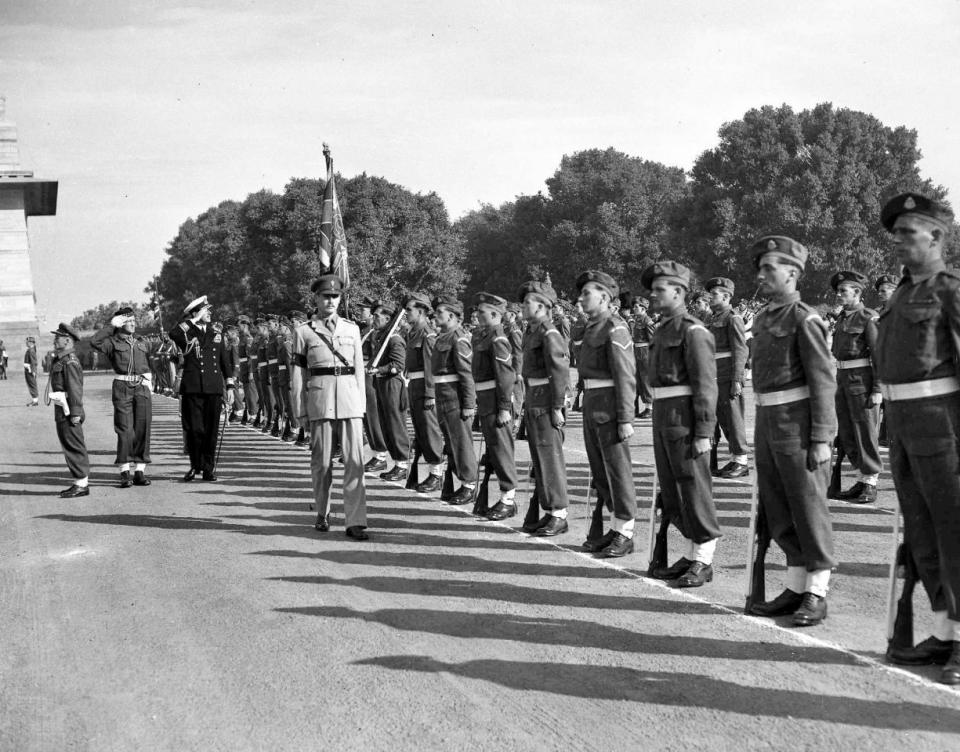 India Last British Troops: Britain’s Earl Mountbatten, in naval uniform, left, salutes the colours as he inspects the farewell parade of the last battalions of the British Army, stationed in Delhi, in the forecourt of Government House, Delhi, Dec. 19, 1947. The last battalions are from the Royal Scots Fusiliers and the East Lancashire regiments. (AP Photo)