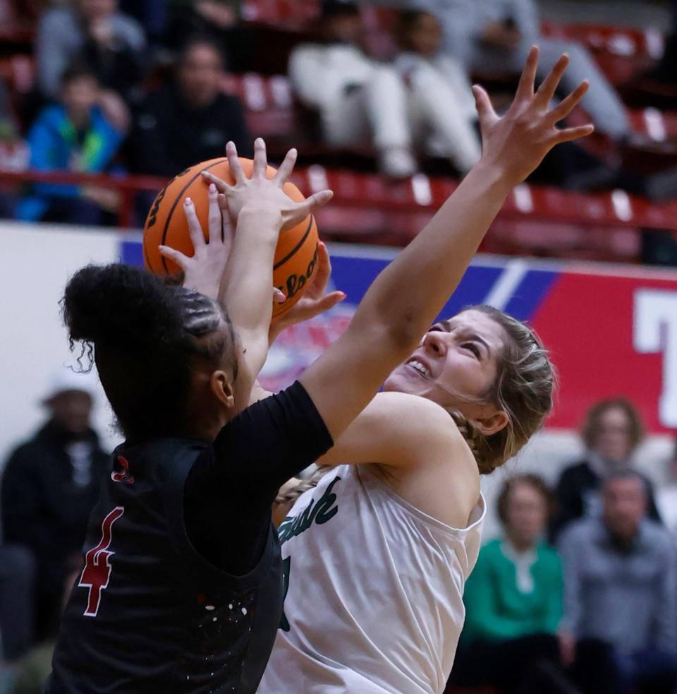 Ann Arbor Richard's Vanessa Rodriguez drives for the basket and is stopped by the defense of Toledo Catholic Central's Corniya Clay during the second half of Richard's 61-47 win in the Catholic League girls basketball final on Saturday, Feb. 17, 2024, at Calihan Hall.