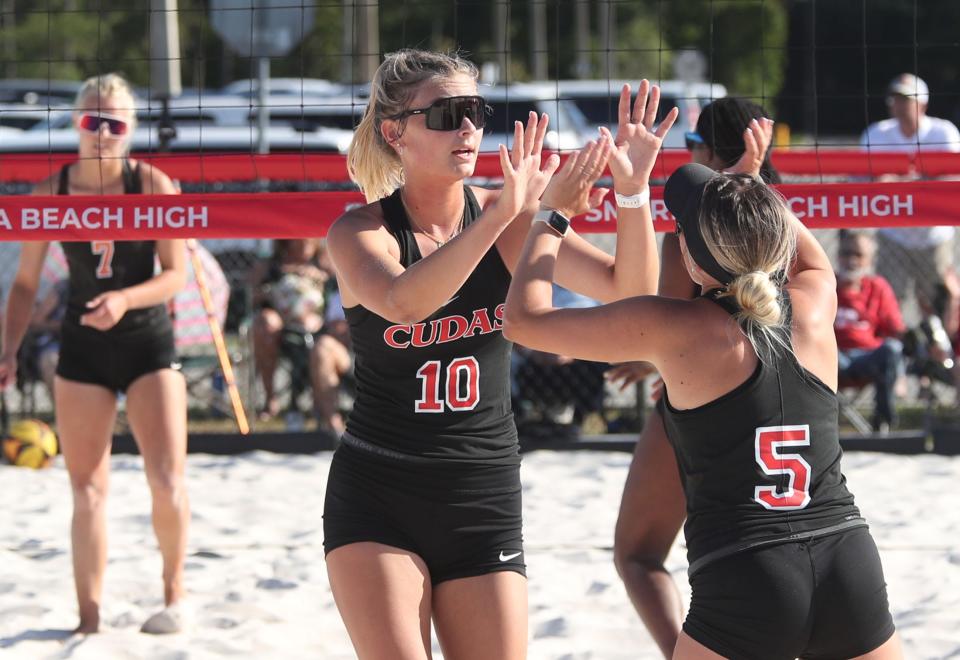 New Smyrna Beach's Kaelyn Fredette-Huffman (10) and Libby Nickels (5) high five after a point against Spruce Creek during the District 7-1A finals, Wednesday, April 24, 2024, at New Smyrna Beach High School.