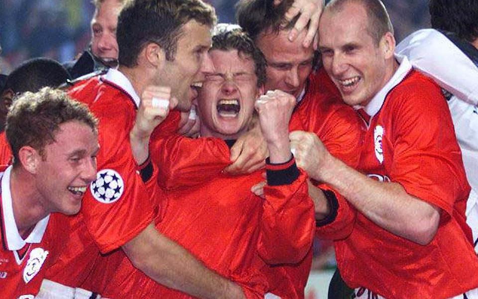 'And Solskjaer has won it!': The United striker is mobbed after scoring the winning goal against Bayern Munich in 1999