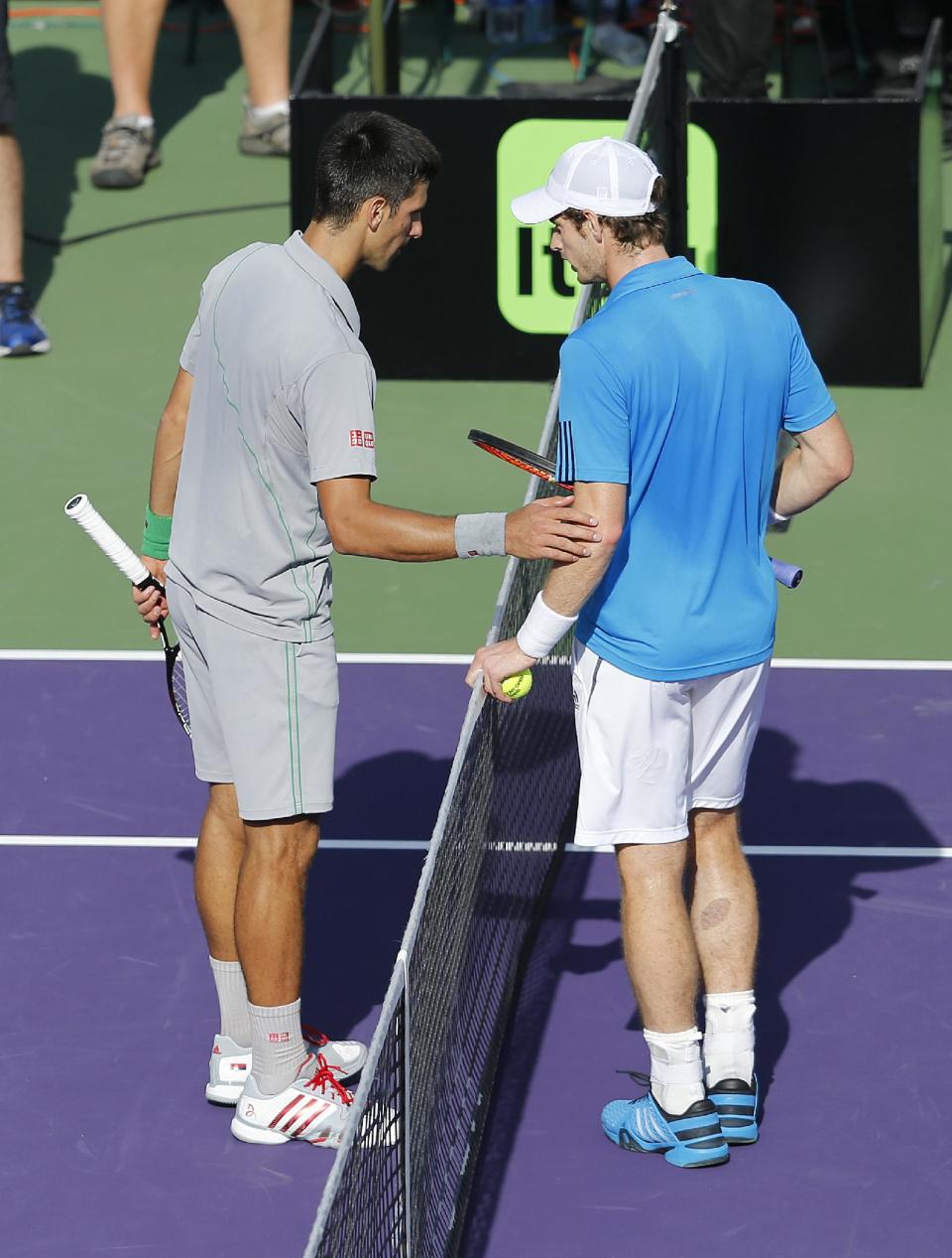 Andy Murray, right, of Britain, and Novak Djokovic, of Serbia, discuss a disputed call at the Sony Open Tennis tournament in Key Biscayne, Fla., Wednesday, March 26, 2014. Djokovic defeated Murray 7-5, 6-3. (AP Photo/Joel Auerbach)