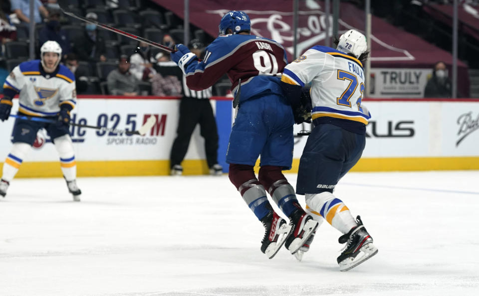 Colorado Avalanche center Nazem Kadri, left, hits St. Louis Blues defenseman Justin Faulk in the third period of Game 2 of an NHL hockey Stanley Cup first-round playoff series Wednesday, May 19, 2021, in Denver. Kadri was removed from the game for the hit. Colorado won 6-3. (AP Photo/David Zalubowski)